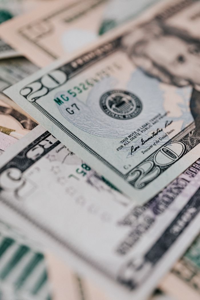 services-05 Closeup of diverse dollar banknotes randomly placed on surface