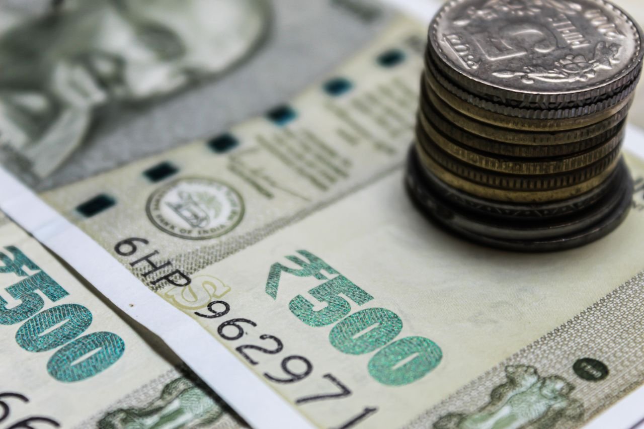 why-choose-us Detailed view of Indian rupees and stacked coins, representing currency and finance.